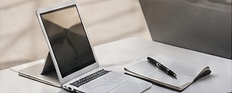 Laptop and notebook on a desk